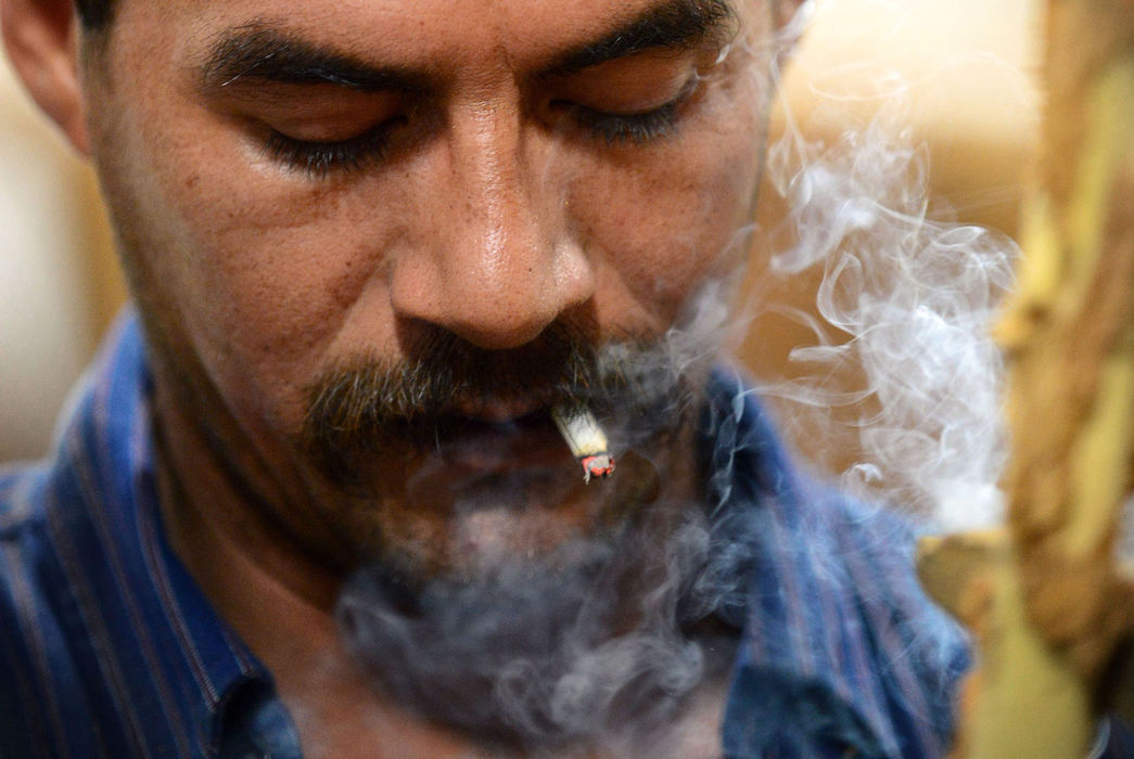 Third Place, Student Photographer of the Year - Logan Riely / Ohio UniversityMoreno Hernandez concentrates while stripping  tobacco. Moreno, who left his wife and children in Mexico City, has worked for the Knotts for the past seven months.