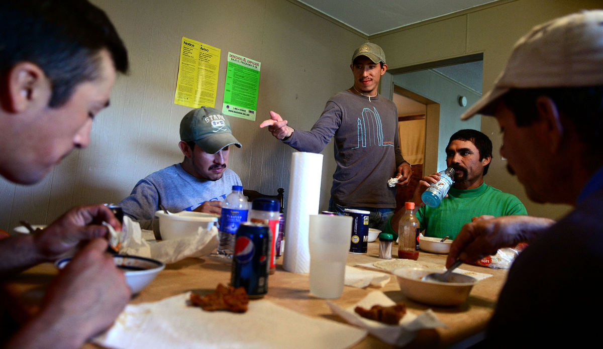 Third Place, Student Photographer of the Year - Logan Riely / Ohio UniversityRaphael Moreno points to his younger brother, Miguel, during a lunch conversation with the other migrant workers in their home on the Knott's 4,000-acre farm. The Moreno brothers left their families in Michoacán, Mexico, and have worked on the farm for the past four months.