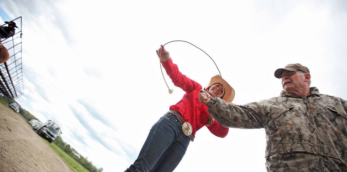 Second Place, Sports Picture Story - Chris Russell / The Columbus DispatchJosie Hume uses her father Jim's forearm to practice her goat tying skills before competing in the event in a competition. 