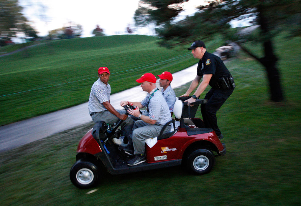 Third Place, Sports Picture Story - Adam Cairns / The Columbus DispatchTiger Woods and Matt Kuchar of the United States Team are driven back to the clubhouse after play was halted because of darkness during the Presidents Cup at Muirfield Village Golf Club on Oct. 4, 2013.