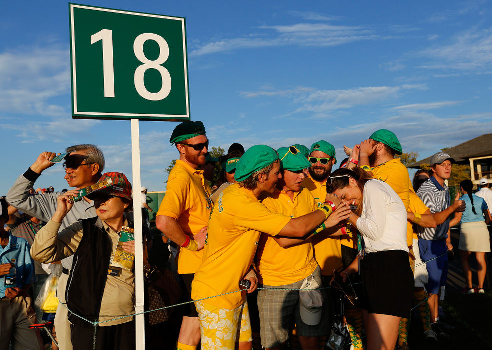 Third Place, Sports Picture Story - Adam Cairns / The Columbus DispatchA group of boisterous Australian fans joke around with Australian golfer Jason Day's wife Ellie Day beside the 18th green following the Presidents Cup at Muirfield Village Golf Club on Oct. 3, 2013.