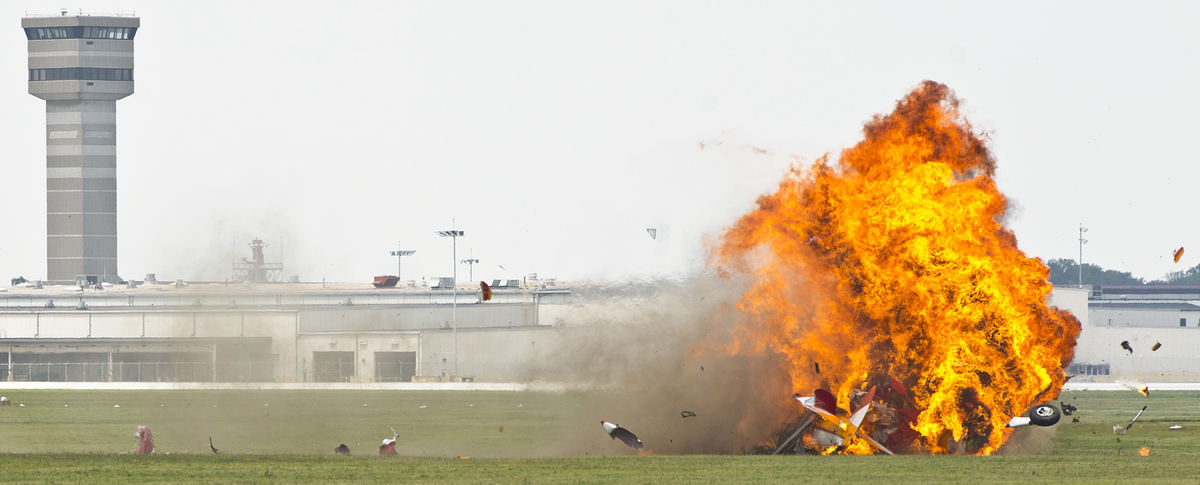 Second Place, Spot News - Small Market - Isaac Hale / Ohio UniversityA vintage stearman aircraft carrying wing walker Jane Wicker and pilot Charlie Schwenker crashes at the Vectren Dayton Air Show in front of a crowd of spectators. Both Wicker and Schwenker were fatally injured in the crash.