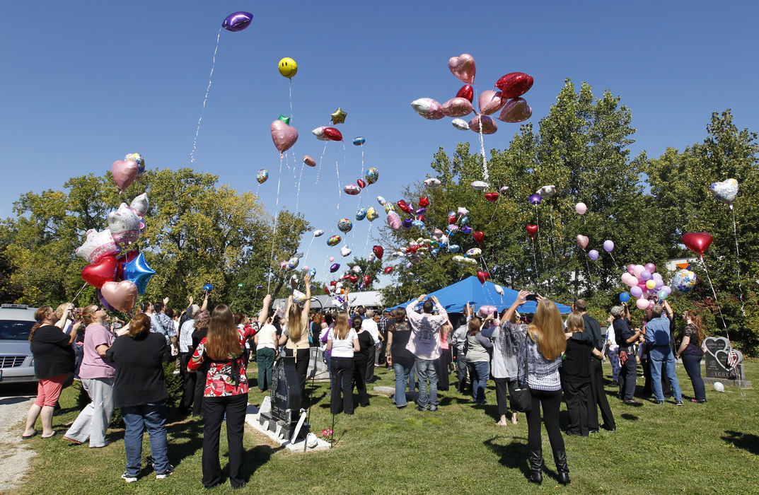 First Place, Team Picture Story - Lori King / The (Toledo) Blade Balloons are released  at the Lake Township Cemetery in Millbury, Ohio, following the funeral for Elaina Steinfurth.