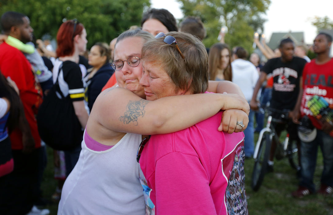 First Place, Team Picture Story - Andy Morrison / The (Toledo) BladePeggy Arnold, left, hugs Ginger Smith, cousin of Terry Steinfurth Sr., during a vigil for Elaina Steinfurth.