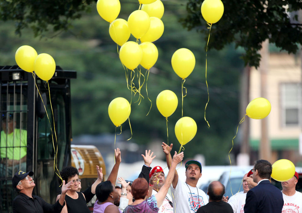 Second Place, Team Picture Story - Marvin Fong / The Plain DealerAs the house where they were help captive is destroyed, balloons are released to mark a new beginning for  Amanda Berry, Gina DeJesus and Michelle Knight.  The women were home, at last.