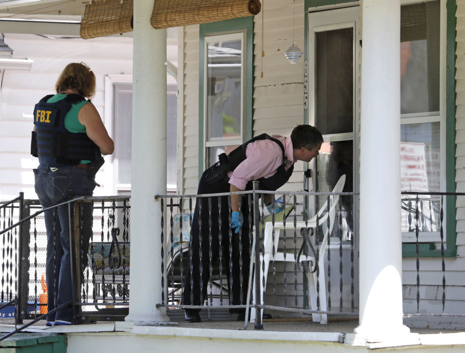 First Place, Team Picture Story - Dave Zapotosky / The (Toledo) BladeLaw enforcement officials canvas homes on Federal Street in East Toledo on Tuesday, June 4, 2013, as they search for 1-1/2-year-old Elaina Steinfurth who was reported missing on Sunday. 