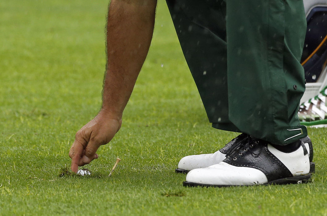 Third Place, Team Picture Story - Kyle Robertson / The Columbus DispatchAngel Cabrera of the International Team picks up his ball out of the fairway after his tee shot on the 2nd hole during the final round of the Presidents Cup at Muirfield Village Golf Club in Dublin, Ohio on October 6, 2013. (Dispatch photo by Kyle Robertson)