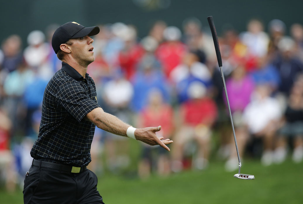 Third Place, Team Picture Story - Eamon Queeney / The Columbus DispatchGraham Delaet of the International Team reacts after missing a putt on the 14th green of singles matches during the final round of the Presidents Cup at Muirfield Village Golf Club in Dublin, Ohio, Sunday afternoon, October 6, 2013. The Americans held on to the Presidents Cup in a rain and mud soaked final round win over the International Team with a score of 18.5 - 15.5. 