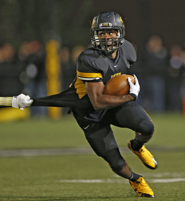 , Ron Kuntz Sports Photographer of the Year - Chris Russell / The Columbus DispatchOhio Dominican's #14 Abe Johnson slips past a Findlay defender on his way to a large gain in the first half at Panther Field .   Ohio Dominican defeated  Findlay 41 to 21. Johnson caught seven passes for 86 yards and scored one touchdown.