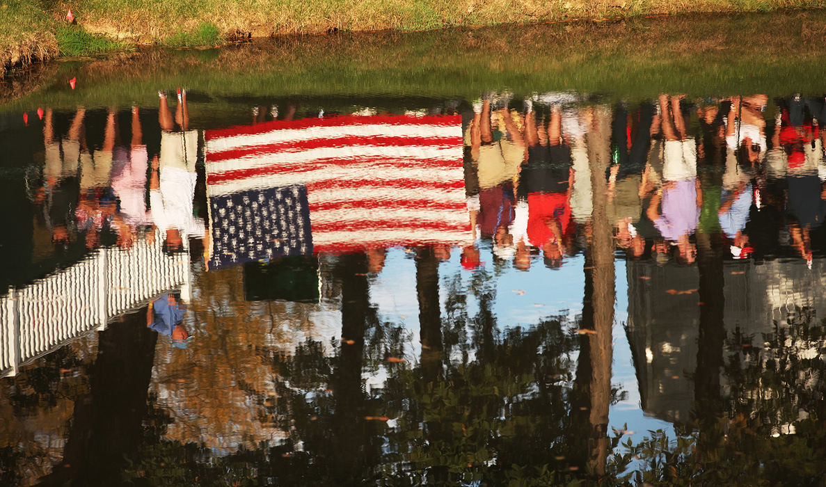 Award of Excellence, Ron Kuntz Sports Photographer of the Year - Chris Russell / The Columbus DispatchA hillside of people show their allegiance by holding an American flag in this impressionistic photo  at the twelve hole during the first round of the Presidents Cup at Muirfield Village Golf Club in Dublin, Ohio on October 3, 2013.  