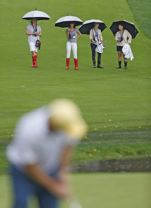 Award of Excellence, Ron Kuntz Sports Photographer of the Year - Chris Russell / The Columbus DispatchGirlfriends and wives follow the fourth round group of Jason Dufner of the United States Team and teammate Zach Johnson, Richard Sterne of the International Team and his partner Marc Leishman  during the fourth round of the Presidents Cup at Muirfield Village Golf Club  on October 5, 2013.  