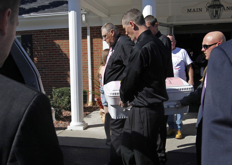 First Place, Team Picture Story - Lori King / The (Toledo) Blade Terry Steinfurth Sr., grandfather of Elaina Steinfurth, left, and her father Terry Steinfurth Jr.,center, carry Elaina's casket to the hearse at the Eggleston Meinert & Pavley Funeral Home in Oregon, Ohio.