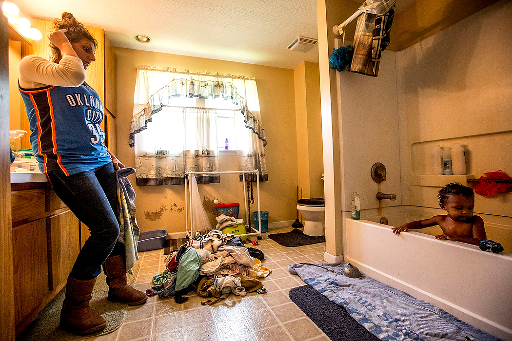 First Place, Feature Picture Story - Jessica Phelps / Newark AdvocateAfter returning from her court hearing, Michele, exhausted and stressed from the day, gives her son, Syncere, a bath. Michele just keeps reminding herself its one day at a time, repeating the mantra from her NA meetings "just for today".