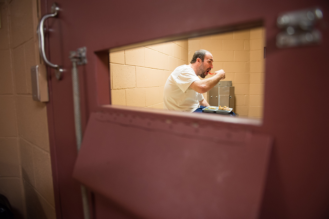 Second Place, Feature Picture Story  - Isaac Hale / Ohio UniversityThomas Browning has a meal in a holding cell soon after being admitted to the facility. Depending on the program they're put in, residents are incarcerated for five months, six months, or ninety days.