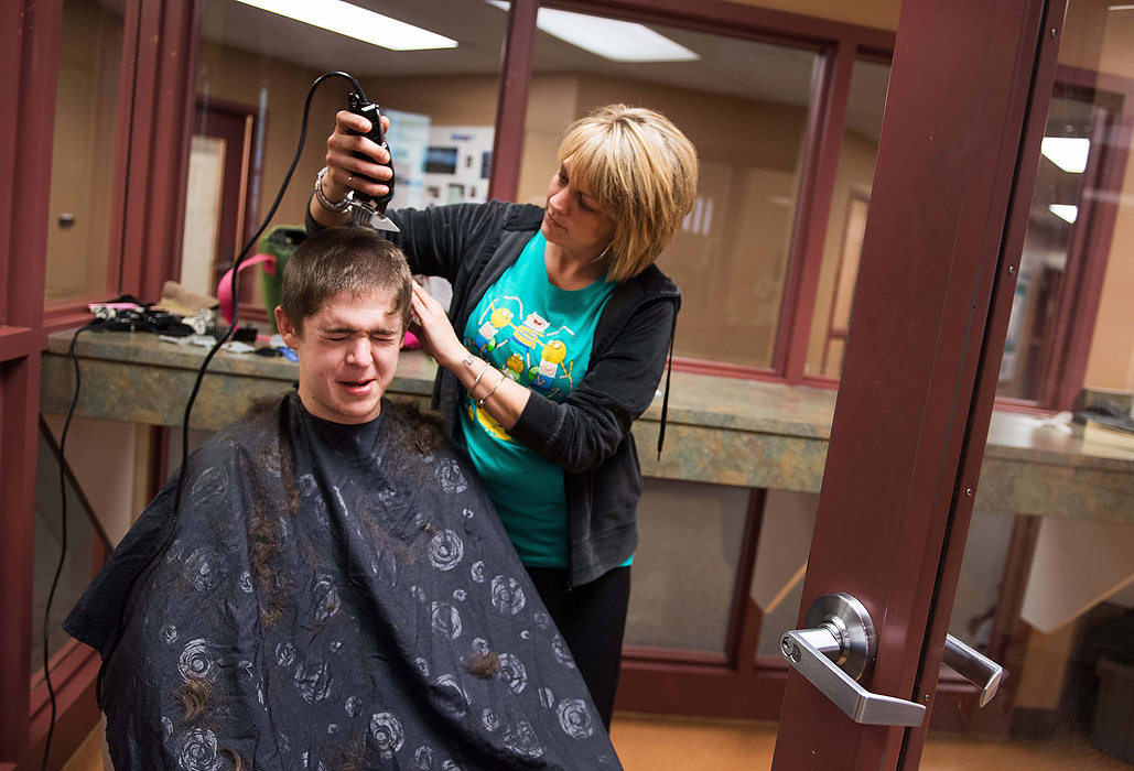 Second Place, Feature Picture Story  - Isaac Hale / Ohio UniversityOnce a month, the facility brings in a stylist to cut residents' hair. Inmate Kevin "Turtle" Busch gets his hair cut by Jennifer Moleski. Once a month, the facility brings in a stylist to cut residents' hair.