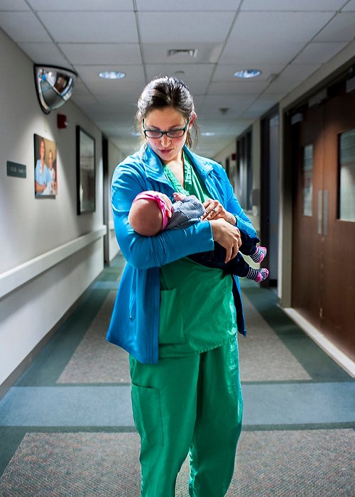 Third Place, Feature Picture Story - Logan Riely / Ohio UniversityDr. Gerlach comforts 6 week old baby girl Kameron Colwell while on break. Kameron is the daughter of one of the attending nurses on the labor and delivery floor. 