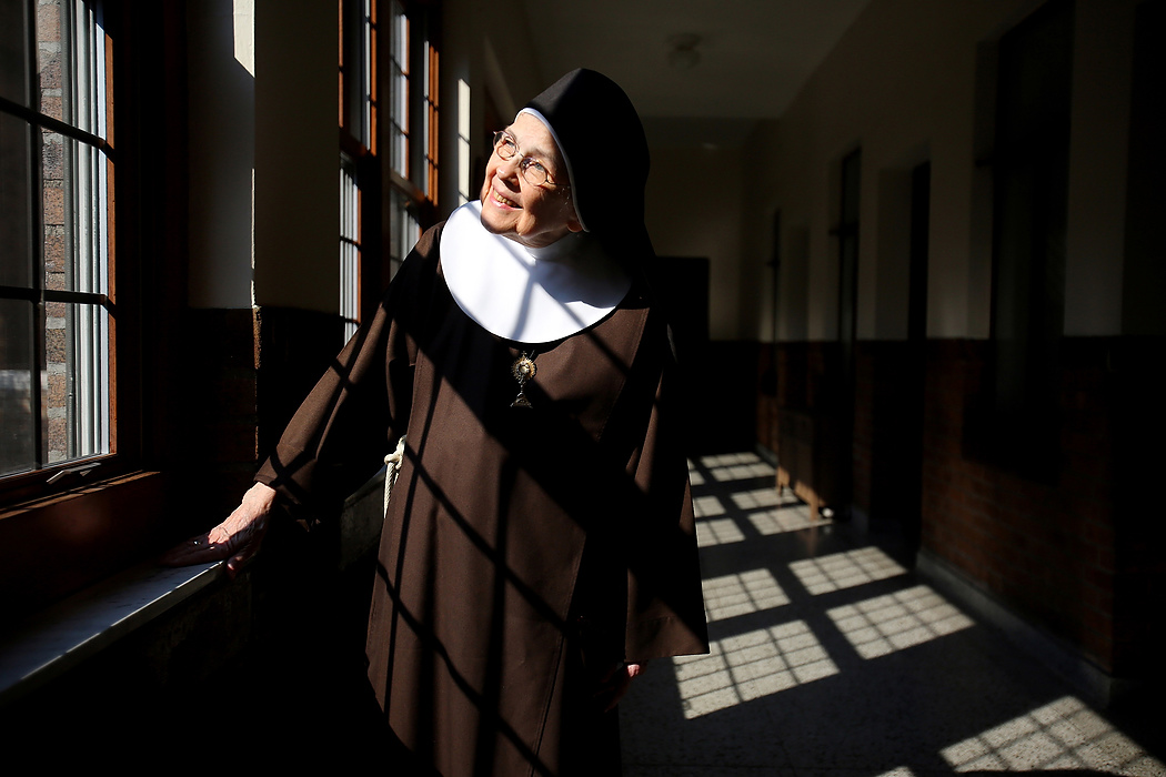 Award of Excellence, Feature Picture Story - Lisa DeJong / The Plain DealerMother Mary Thomas, 81, says she has been blessed by good light inside the Adoration Monastery where she has lived for 55 years.  No more than five feet tall, Mother Thomas is a member of the Poor Clares of Perpetual Adoration, a cloistered order tracing its origins to the early 13th century. These days, she toils cheerfully on a mural many times her size. Currently, Mother Thomas, 81, spends hours on her knees painting a 30 x16-foot mural that she hopes to present to the pope when he arrives in Philadelphia in September.  "Art is chiefly a prayer for me, an expression of my love for God and His people," she said. Mother Mary Thomas has painted in vivid colors for over 60 years, influenced by studying mural painting in Mexico in her early 20s. A teacher encouraged her to go to the Chicago Institute of Art because, she was told, her work already reflected the influence of Diego Rivera, the famed Mexican muralist. Later, she would work with David Alfaro Siqueiros, a muralist in Mexico. After World War I, the Mexican Muralism style evolved with the intent of creating public art as visual narrative, especially as a means of social commentary and historical perspective.  In 1958, at the age of 25, she went to Rome to further study and paint. During an Easter prayer vigil at St. Peter's Basilica, she said, she was overcome with an intense sense of joy and knew then that joining a religious order was her vocation.  "If you told me then that I would end up in a cloistered order of nuns, I would not have believed it," she said. 