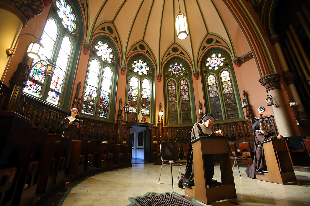 Award of Excellence, Feature Picture Story - Lisa DeJong / The Plain DealerMother Mary Thomas, 81, kneels as she prays in the private, cloistered chapel of The Church of the Conversion of St. Paul. One of the 18 sisters is perpetually praying here, 24 hours a day. She actually gave up painting for about 12 years, after she joined the order, until 1972 when she started painting religious themes for the church.  