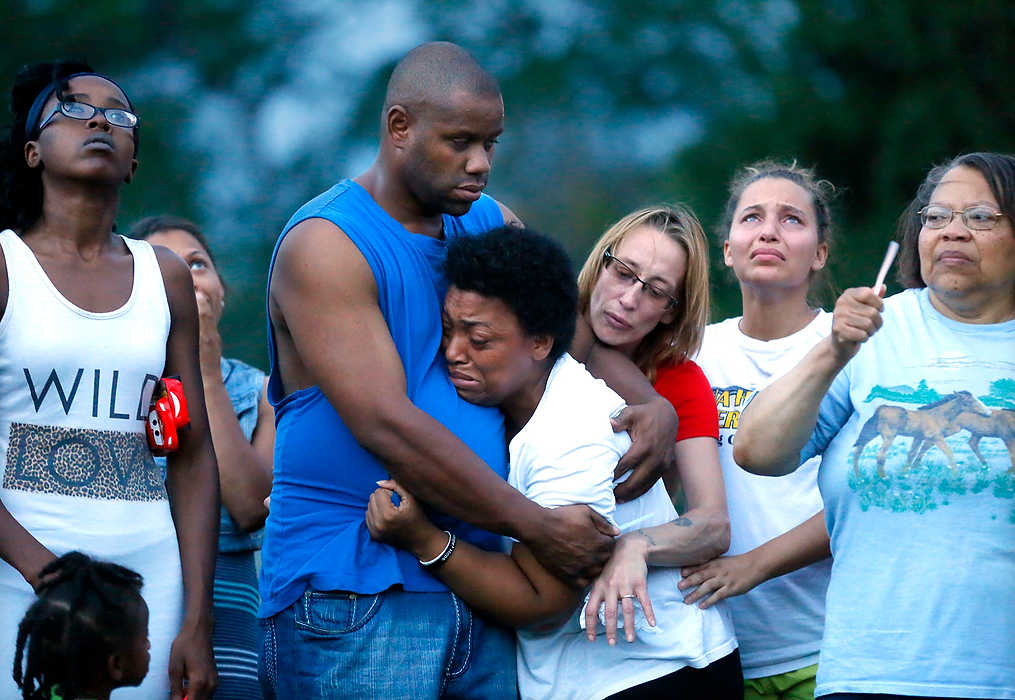 First Place, General News - Amy E. Voigt / The (Toledo) BladeAlexis Caldwell, the mother of Danika Caldwell (center) mourns while she is comforted by cousin Eugene Frazier (left) and friend, Taffy Malkowski (right) during a vigil at Old Orchard Elementary for first grader Danika Caldwell who was killed in a fire. Danika Caldwell's Aunt, Yvonne Frazier, (far right) in blue with glasses, holds a candle.