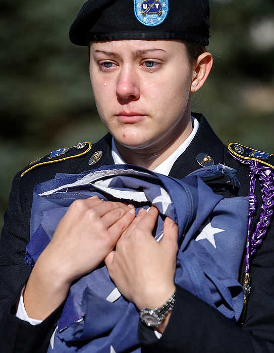 Third Place, General News - Andy Morrison / The (Toledo) BladeAn emotional Michelle Janollari holds an American flag during the playing of the National Anthem, as the Student Veterans of America UT Chapter retires several American flags during a ceremony near the Student Union at the University of Toledo. The Avon, Ohio native said the event had a real emotional impact so close to Veteran's Day.