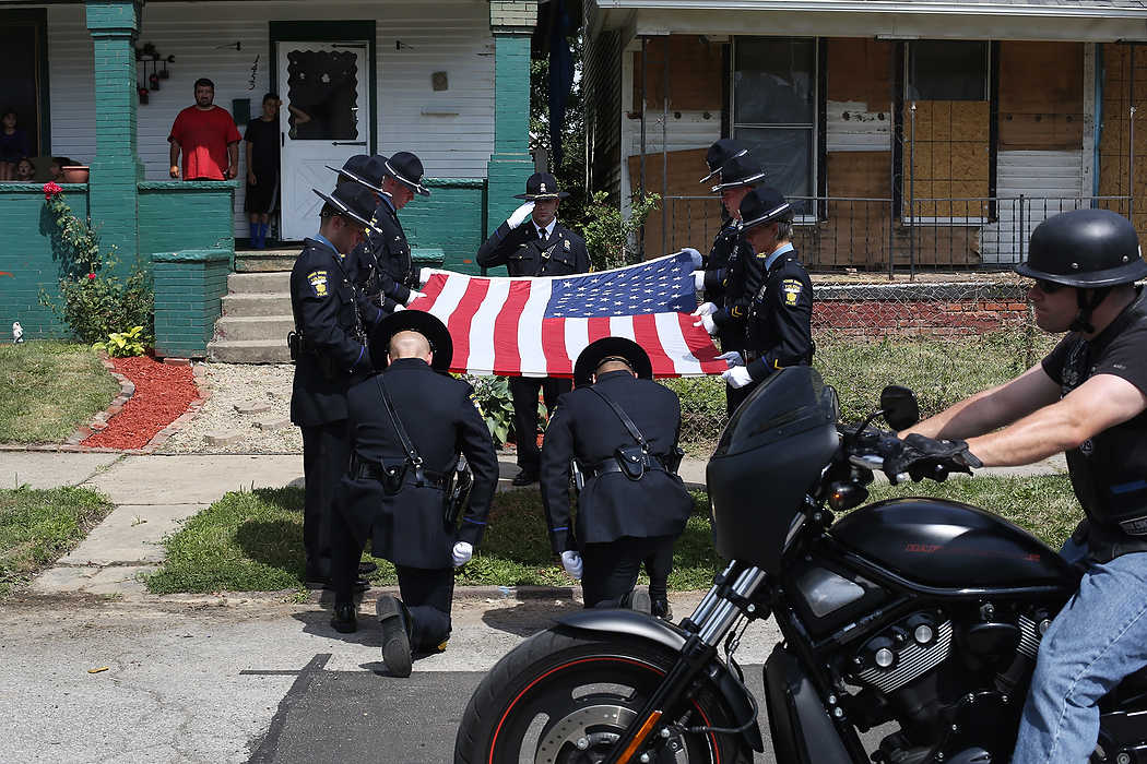 Award of Excellence, General News - Katie Rausch / The (Toledo) BladeThe Toledo Police Department Honor Guard holds vigil as bikers pass slowly by the spot where Toledo Detective Keith Dressel was shot on Ontario Street in North Toledo during the eighth Keith Dressel Memorial Ride. Several hundred bikers banded together for roughly 60-mile-long ride through Toledo, including the neighborhood where Detective Dressel was shot and killed in 2007.