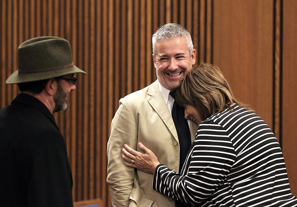 First Place, News Picture Story - Lisa DeJong / The Plain DealerBlaine Murphy laughs as neighbor and good friend Lynda Lewis laughs and cries at the same time on his shoulder after Judge Richard McMonagle lets him go home to Florida after serving less than his 3,000 hours of community service. The two have grown very close and Lewis is heartbroken on many levels that Murphy is leaving town. On left is councilman Tony Brancatelli, his de facto probation officer. Murphy is struck by the ironic friendships created by the unique sentencing by Judge McMonagle. Lewis says she will visit her "son" in Naples, Florida, every winter. 