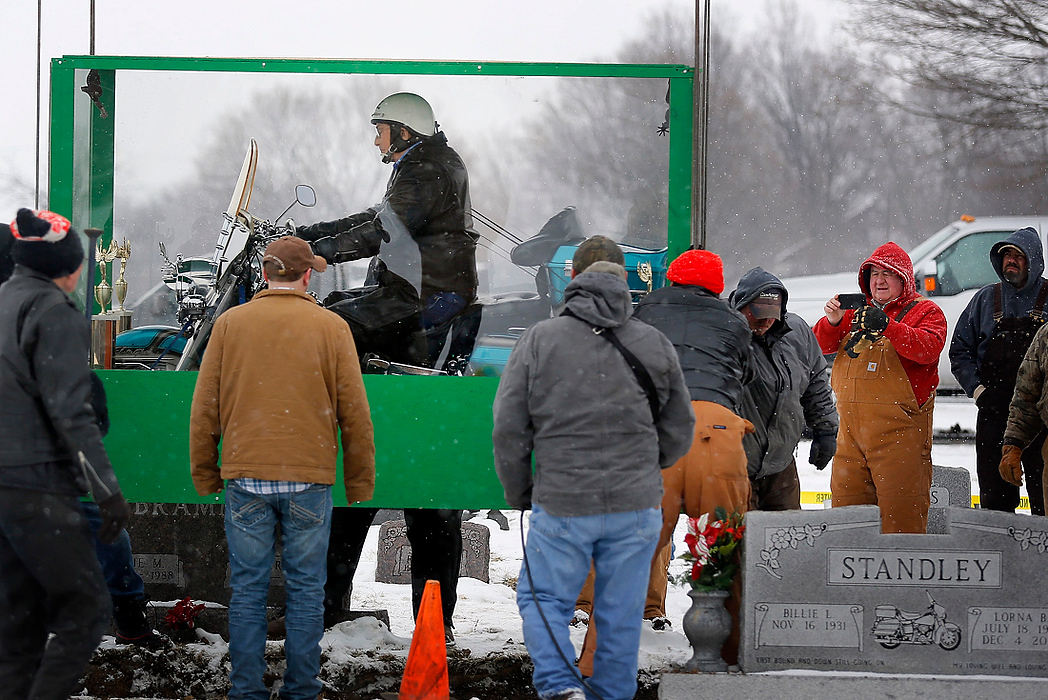 Second Place, News Picture Story - Jonathan Quilter / The Columbus DispatchThe body of Bill Standley, secured to his 1967 Harley Davidson, rests inside a plexiglass box before being lowered into the ground at the cemetery in Mutual, Ohio.