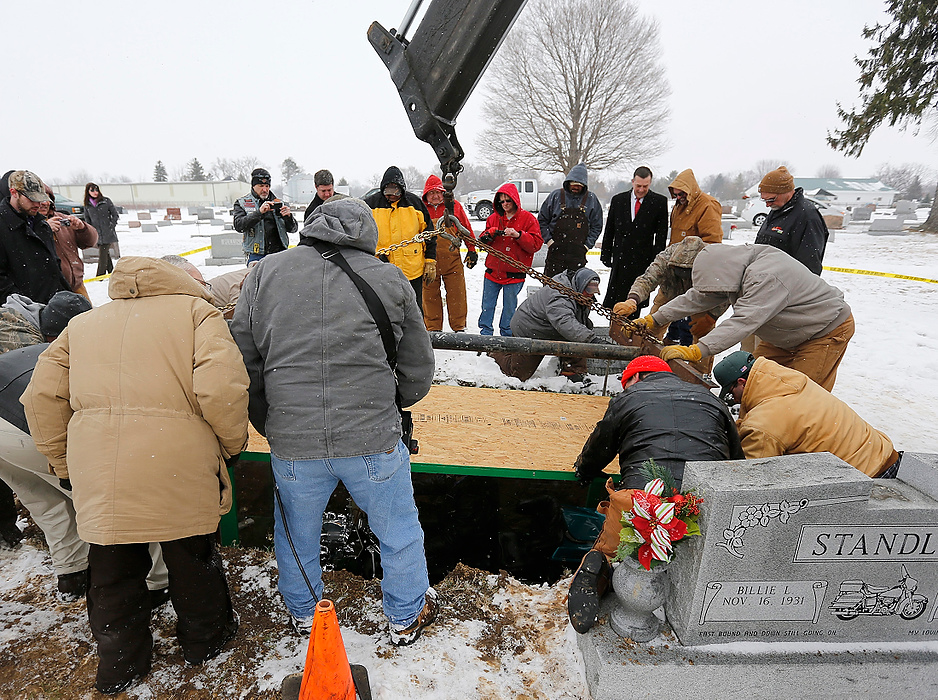 Second Place, News Picture Story - Jonathan Quilter / The Columbus DispatchThe body of Bill Standley, secured to his 1967 Harley Davidson, is  lowered into the ground at the cemetery in Mutual, Ohio.