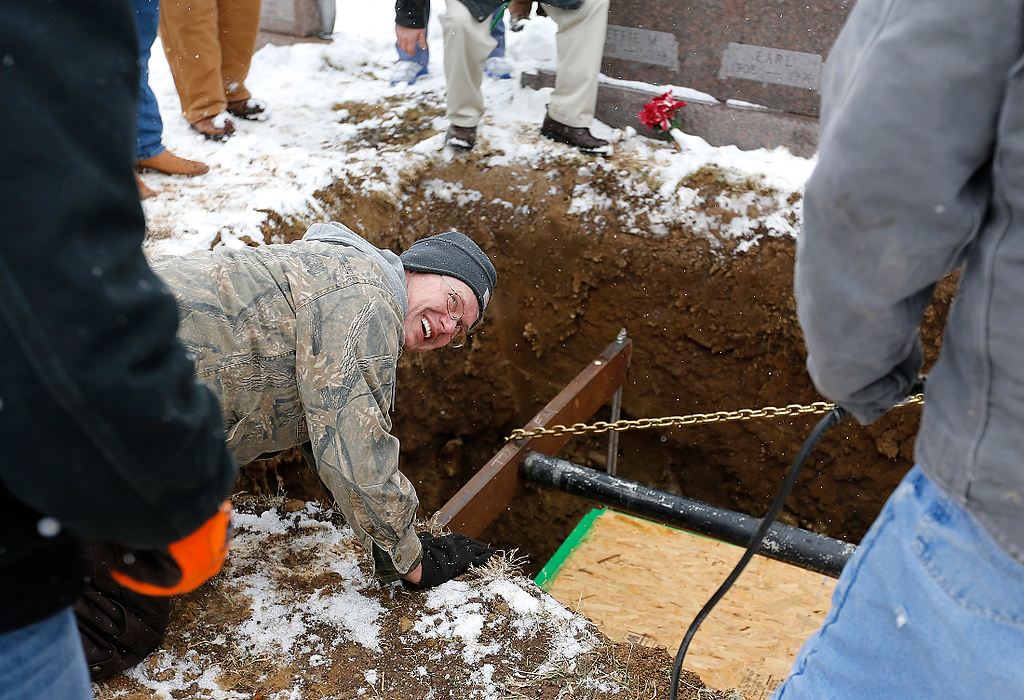 Second Place, News Picture Story - Jonathan Quilter / The Columbus DispatchRoy Standley is pleased with how well the lowering of his dad's body went at the cemetery in Mutual, Ohio.