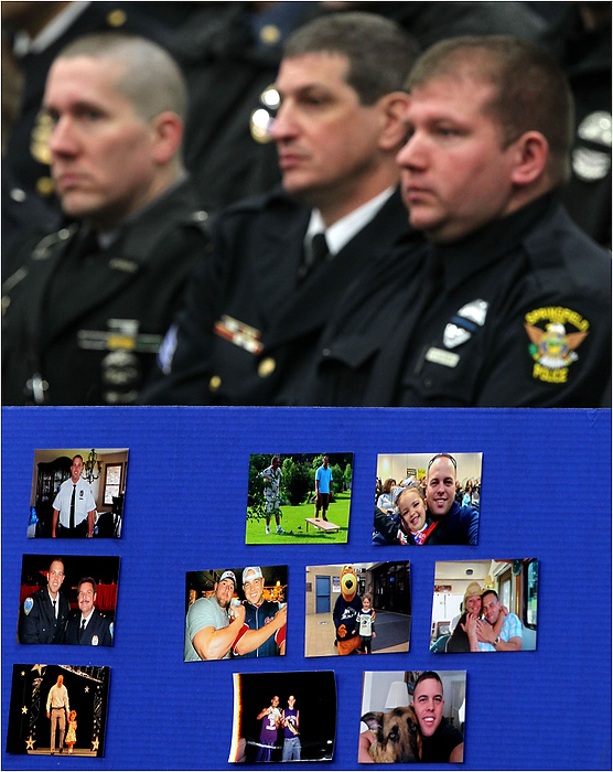 Third Place, News Picture Story - Ed Suba Jr. / Akron Beacon JournalFamily photos of Akron Police Officer Justin Winebrenner sit below a group of area police officers attending a memorial service for Winebrenner at the James A. Rhodes Arena in Akron.
