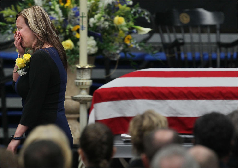 Third Place, News Picture Story - Ed Suba Jr. / Akron Beacon JournalTiffany Miller, the fiancee of Akron Police Officer Justin Winebrenner, is overcome with tears while walking past his casket during a memorial service for him at the James A. Rhodes Arena in Akron.