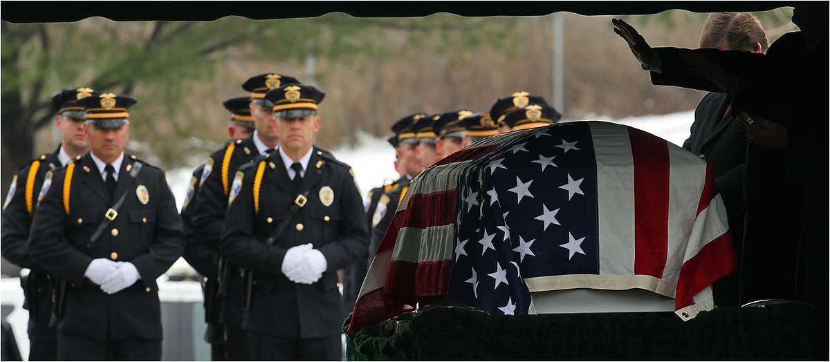 Third Place, News Picture Story - Ed Suba Jr. / Akron Beacon JournalArea police officers stand at attention as a prayer is said during the internment service for Akron Police Officer Justin Winebrenner at Holy Cross Cemetery in Akron.