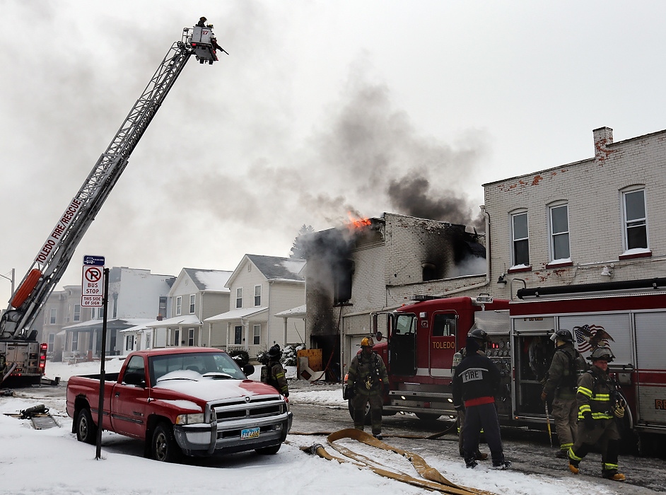 Award of Excellence, News Picture Story - Jetta Fraser / The (Toledo) BladeToledo firefighters respond to a fire in a six-unit apartment building at 528 Magnolia on Sunday Jan. 26, 2014. Two firefighters were killed; the residents escaped, but most of their belongings were destroyed. Toledo police has charged the building's owner with arson. Toledo firefighters at the apartment complex near downtown Toledo battle a blaze in a small complex.