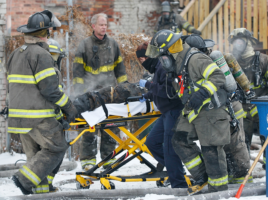Award of Excellence, News Picture Story - Jetta Fraser / The (Toledo) BladeToledo firefighters rush a fellow firefighter to a waiting ambulance after bringing him down from the second floor at the rear of a six unit apartment building at 528 Magnolia in Toledo.