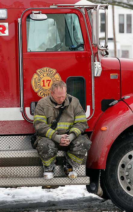 Award of Excellence, News Picture Story - Jetta Fraser / The (Toledo) BladeA Toledo firefighter outside of 528 Magnolia in Toledo after the second of two firefighters' bodies had been taken from the scene.