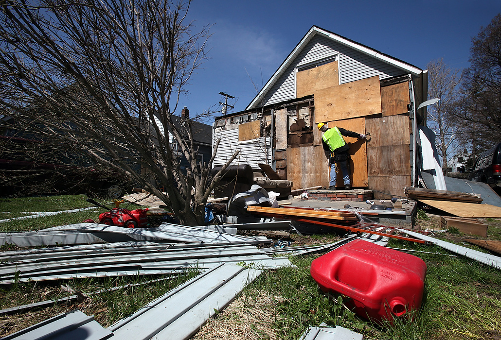 First Place, News Picture Story - Lisa DeJong / The Plain DealerBlaine Murphy boards up yet another abandoned house on Huss Avenue in Slavic Village. Vandals tore the old boards off. Murphy is working with the Slavic Village Development Corporation and combing the neighborhood for code violations, such open vacant homes. 