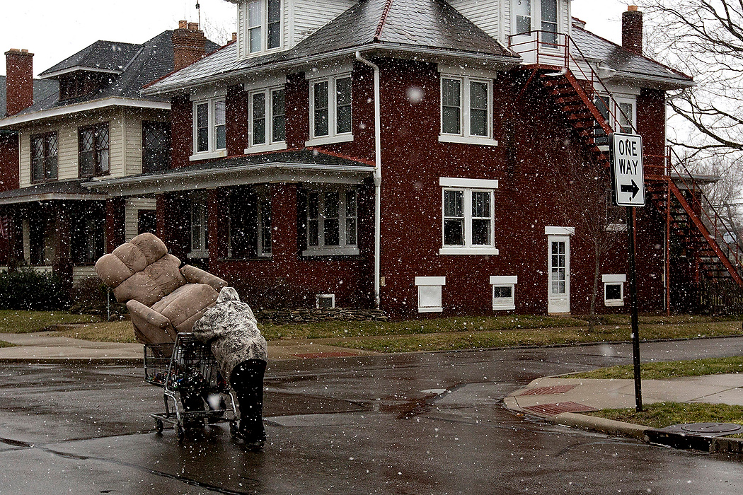 First Place, James R. Gordon Ohio Understanding Award - Jessica Phelps / Newark AdvocateOn a snowy afternoon a man walks down Rich Street with a shopping cart full items including a sofa chair.