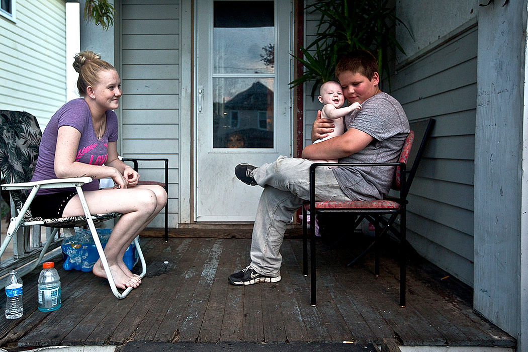 First Place, James R. Gordon Ohio Understanding Award - Jessica Phelps / Newark AdvocateCaitlin, 16, sits with her daughter Eva and younger brother Brennen on their front porch. Caitlin got pregnant at 15 and remains at her parents house in Franklinton. 