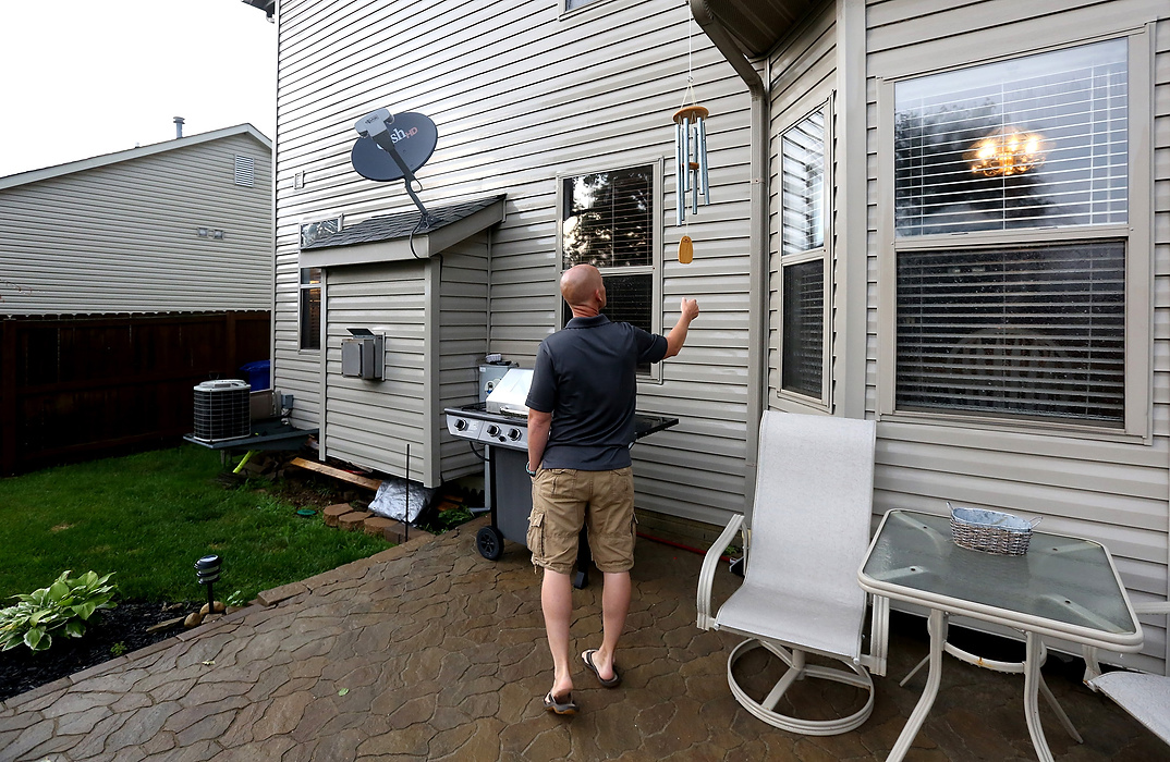 Second Place, James R. Gordon Ohio Understanding Award -  / The Columbus DispatchBrian Conrad reaches for a set of chimes given to he and his wife Niki Conrad as a gift of remembrance at their home in Blacklick, Ohio on July 7, 2014. The Conrads kept many of the mementos they were given after losing their son Blake Conrad to extreme prematurity. Their nursery still contains his crib, a changing table, and other products they purchased before losing their son. "I feel that when I hear the chimes, he's talking to us," Brian said after learning of others they knew who had lost children,  “We were shocked at how many families this has affected."