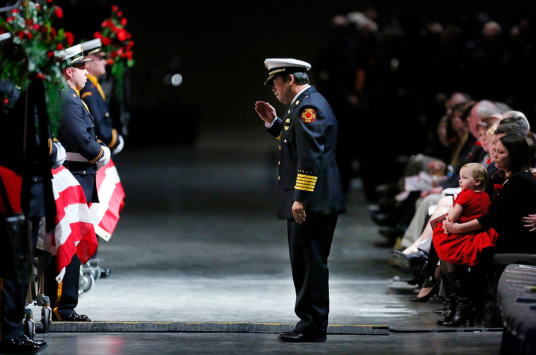 Third Place, Photographer of the Year - Large Market - Andy Morrison / The (Toledo) BladeToledo Fire Chief Luis Santiago salutes the casket of firefighter James Dickman during the Last Alarm funeral service at SeaGate Convention Centre.  Firefighters Dickman and Stephen Machcinski were killed fighting a fire.