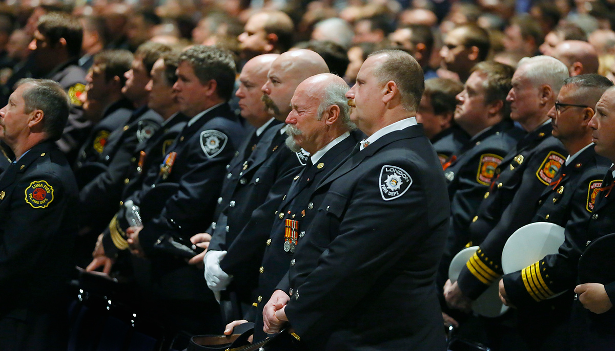 Third Place, Photographer of the Year - Large Market - Andy Morrison / The (Toledo) BladeFirefighters stand as family members enter during the Last Alarm funeral service at SeaGate Convention Centre for Toledo firefighters Stephen Machcinski and James Dickman.