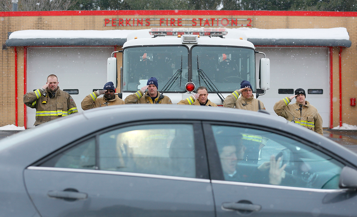 Third Place, Photographer of the Year - Large Market - Andy Morrison / The (Toledo) BladeCity of Sandusky firefighters salute as the Dickman family passes in front of Perkins Fire Station 2, where Toledo firefighter James Dickman used to work, as the funeral processes to Oakland Cemetery.