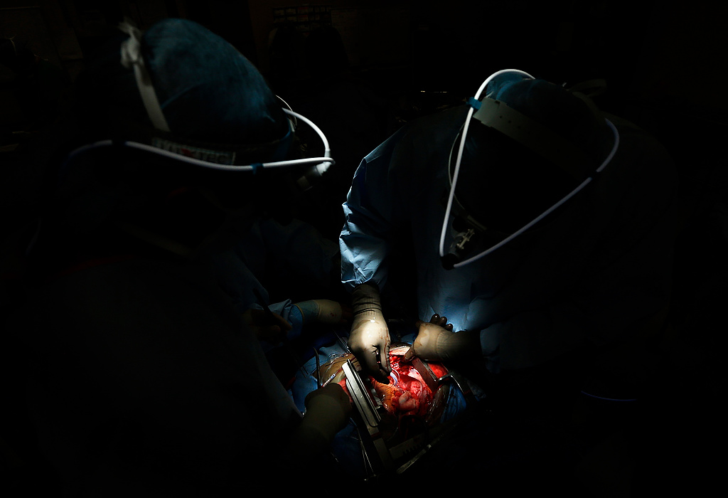 First Place, Photographer of the Year - Large Market - Eamon Queeney / The Columbus DispatchCardiac surgeons Bryan Whitson (right) and Ahmet Kilic (left) work on a patient's new heart during a heart transplant in an operating room at Ohio State University's Ross Heart Hospital in the early morning hours February 12. The number of heart transplants performed in Ohio fell last year to its lowest point since 1989, but not due to less of a waiting list. As of February 7th, 59 percent of the 155 people who were waiting for heart transplants in Ohio had been waiting for at least a year. The highest rate in the nation.