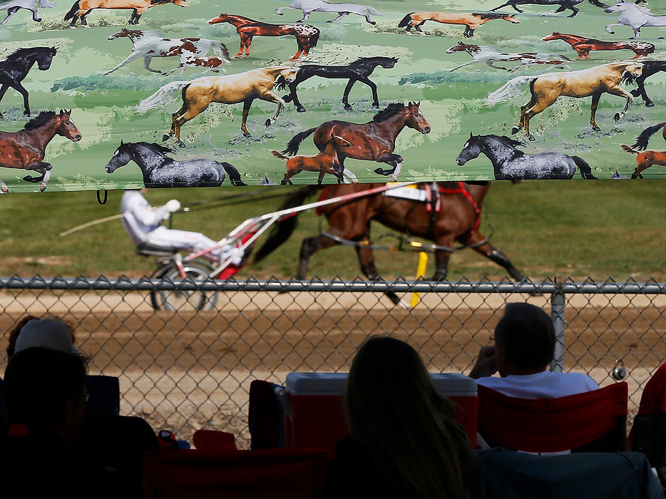 First Place, Photographer of the Year - Large Market - Eamon Queeney / The Columbus DispatchA horse and rider are seen warming up before the 12th race through a horse-themed canopy during the 69th running of the Little Brown Jug at the Delaware County Fairgrounds.