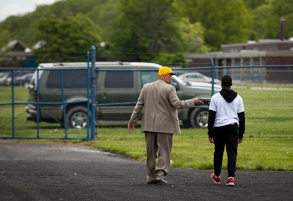 First Place, Photographer of the Year - Large Market - Eamon Queeney / The Columbus DispatchSophomore Nyshawn Ramsey is led back to the school building and pulled from activities by Principal Duane Bland after getting in trouble during field day.