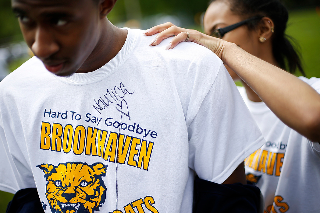 First Place, Photographer of the Year - Large Market - Eamon Queeney / The Columbus DispatchJunior Nautica Jordan signs the back of senior Ronnie Williams' goodbye Brookhaven shirt during field day.