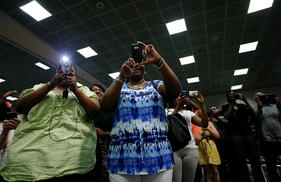 First Place, Photographer of the Year - Large Market - Eamon Queeney / The Columbus DispatchParents try to grab photos and video as their kids enter Brookhaven High School's graduation ceremony at the Greater Columbus Convention Center. The very last senior class of Brookhaven High School received their diplomas in front of a loud and happy crowd of family members and friends. 