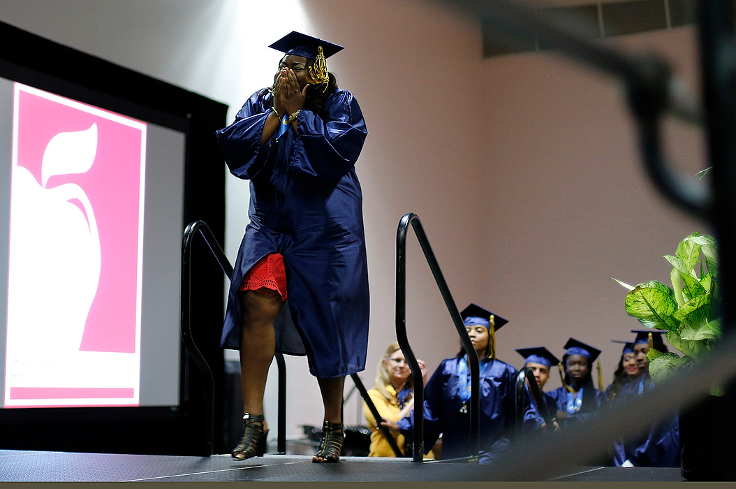 First Place, Photographer of the Year - Large Market - Eamon Queeney / The Columbus DispatchChayla Wigton, 32, reacts as she walks on stage to accept her high school diploma during the graduation ceremony for Brookhaven High School at the Greater Columbus Convention Center. Wigton was supposed to graduate in 2000, but never had high enough test scores. Now after 14 years she got to walk with the final senior class of Brookhaven High School, which closed a few days prior. 