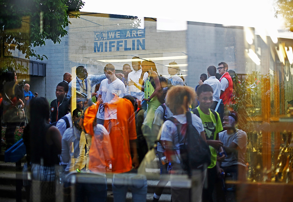 First Place, Photographer of the Year - Large Market - Eamon Queeney / The Columbus DispatchStudents are seen inside and entering Mifflin High School in a reflection of the front doors during the start of the first day of school for Columbus City Schools. While 53,000 students were starting their first day of school the students of Mifflin High School were starting with a host of students from the recently closed Brookhaven High School. 