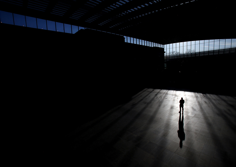 Second Place, Photographer of the Year - Large Market - Lisa DeJong  / The Plain DealerTom Sheppard, 65, of Willoughby, takes pictures of his long shadow in the expansive atrium at the Cleveland Museum of Art. Surmounted by a skylight the size of a football field, sun floods the institution with patterns, changing the mood of the space from one minute to another. At 39,000 square feet, the atrium slightly exceeds the Main Concourse in New York's Grand Central Terminal. The museum has completed it's $320 million expansion and renovation. 